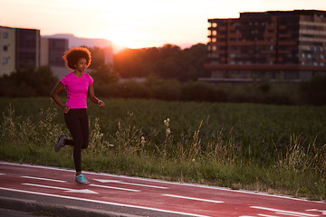 Image showing a young African American woman jogging outdoors