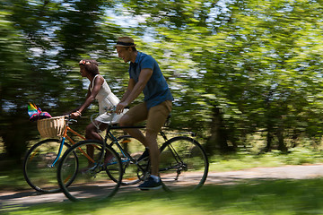 Image showing Young multiethnic couple having a bike ride in nature