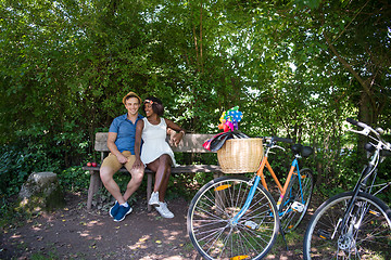 Image showing Young multiethnic couple having a bike ride in nature