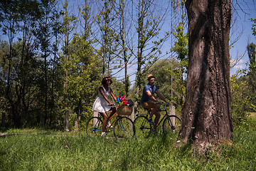 Image showing Young multiethnic couple having a bike ride in nature