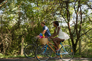 Image showing Young multiethnic couple having a bike ride in nature