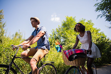 Image showing Young multiethnic couple having a bike ride in nature