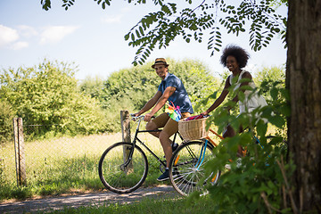 Image showing Young multiethnic couple having a bike ride in nature