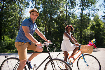 Image showing Young multiethnic couple having a bike ride in nature