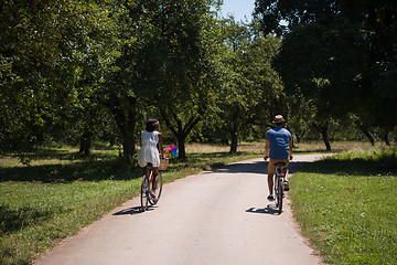 Image showing Young multiethnic couple having a bike ride in nature