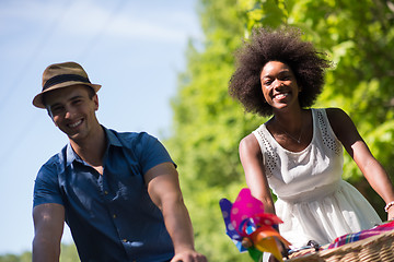 Image showing Young multiethnic couple having a bike ride in nature