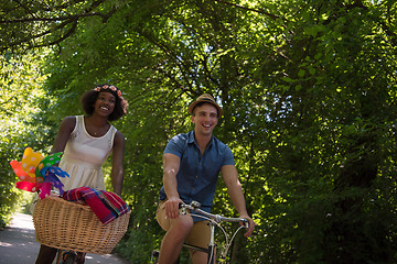 Image showing Young multiethnic couple having a bike ride in nature