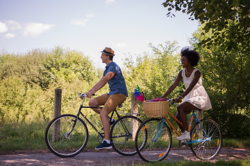 Image showing Young multiethnic couple having a bike ride in nature