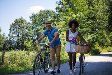 Image showing Young multiethnic couple having a bike ride in nature