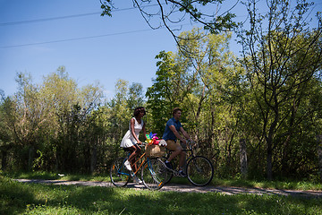 Image showing Young multiethnic couple having a bike ride in nature