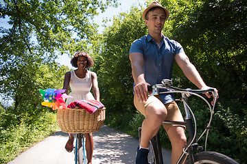 Image showing Young multiethnic couple having a bike ride in nature