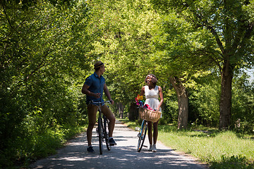 Image showing Young multiethnic couple having a bike ride in nature