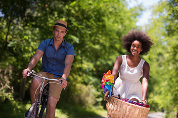 Image showing Young multiethnic couple having a bike ride in nature