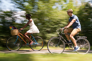 Image showing Young multiethnic couple having a bike ride in nature