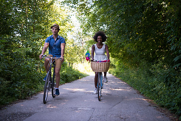 Image showing Young multiethnic couple having a bike ride in nature