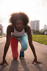 Image showing Portrait of sporty young african american woman running outdoors