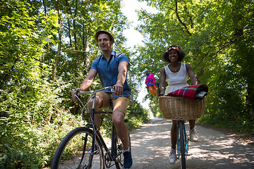 Image showing Young multiethnic couple having a bike ride in nature