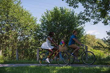 Image showing Young multiethnic couple having a bike ride in nature