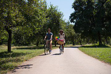 Image showing Young multiethnic couple having a bike ride in nature