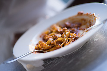 Image showing a young African American woman eating pasta