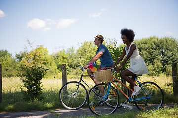 Image showing Young multiethnic couple having a bike ride in nature