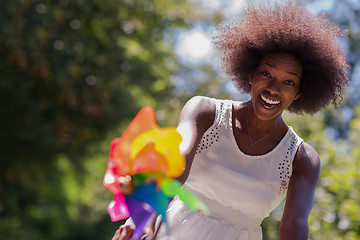 Image showing pretty young african american woman riding a bike in forest