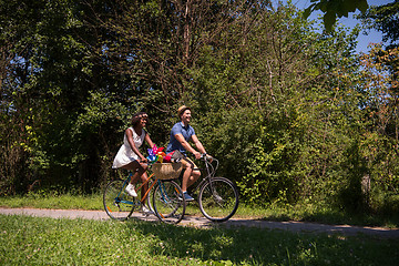 Image showing Young multiethnic couple having a bike ride in nature