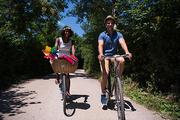 Image showing Young multiethnic couple having a bike ride in nature