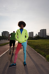 Image showing Portrait of sporty young african american woman running outdoors