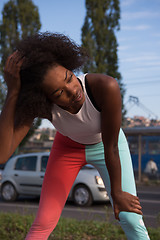 Image showing Portrait of sporty young african american woman running outdoors