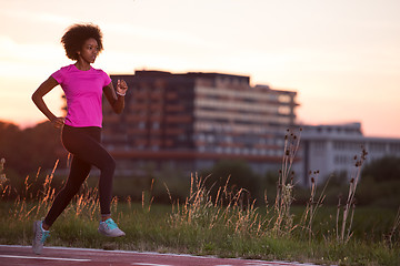 Image showing a young African American woman jogging outdoors