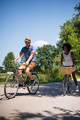 Image showing Young multiethnic couple having a bike ride in nature