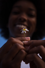 Image showing portrait of African American girl with a flower in her hand