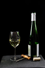 Image showing Bottle and glass of white wine with utensiles