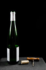 Image showing Uncorked wine bottle with utensiles