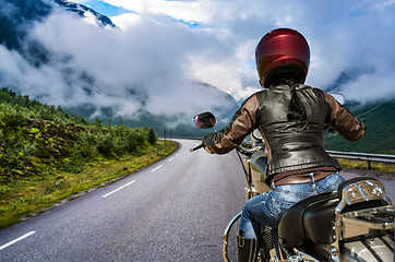 Image showing Biker girl First-person view, mountain serpentine.