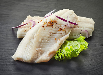 Image showing roasted perch fish fillets on black background