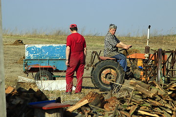 Image showing rural men work with tractor with trailer