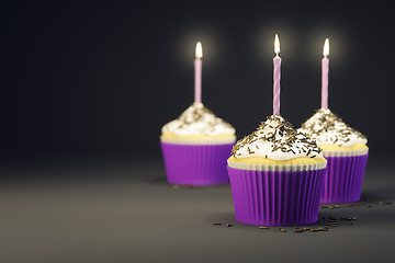 Image showing delicious cupcakes with a burning candles