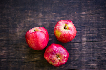 Image showing Three red apples on wooden table