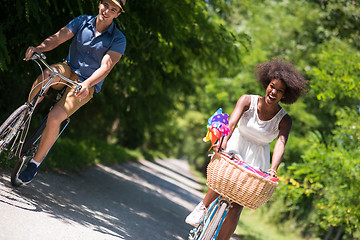 Image showing Young multiethnic couple having a bike ride in nature