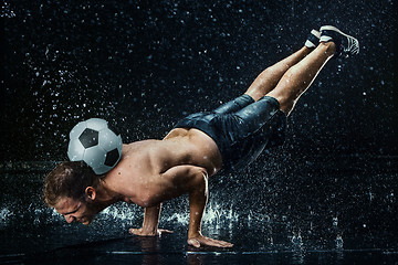 Image showing Water drops around football player