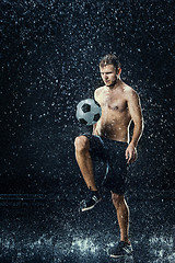 Image showing Water drops around football player