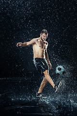 Image showing Water drops around football player