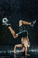 Image showing Water drops around football player