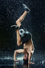 Image showing Water drops around football player