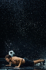 Image showing Water drops around football player