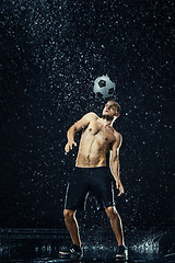 Image showing Water drops around football player