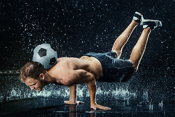 Image showing Water drops around football player