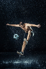 Image showing Water drops around football player